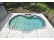 Aerial view of a unique heart-shaped pool surrounded by a screened enclosure at 830 Miami Springs Dr, Longwood, FL 32779