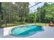 Sparkling pool with an enclosed screened-in patio surrounded by lush greenery offering privacy at 830 Miami Springs Dr, Longwood, FL 32779