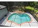 Aerial view of a unique shaped pool with an attached spa and screened enclosure at 830 Miami Springs Dr, Longwood, FL 32779