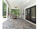 Enjoy outdoor living on this porch with ceiling fan and tile flooring at 830 Miami Springs Dr, Longwood, FL 32779
