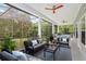 Spacious screened porch with comfortable seating, ceiling fans and view of the backyard at 830 Miami Springs Dr, Longwood, FL 32779
