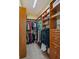 Spacious walk-in closet with custom wood shelving and hanging racks for organized storage at 830 Miami Springs Dr, Longwood, FL 32779