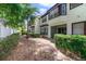 A leafy backyard space with trees offering shade in this well-maintained townhome community at 8414 Frescada Ct, Orlando, FL 32836