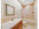 Traditional bathroom featuring a bathtub, tiled walls, and a wood vanity with a white countertop at 8414 Frescada Ct, Orlando, FL 32836