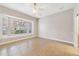 An empty bedroom featuring tile floors, a ceiling fan, and a bright bay window at 8414 Frescada Ct, Orlando, FL 32836
