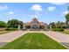 Elegant community entrance with a decorative gatehouse, manicured landscaping, and brick-paved driveways at 8414 Frescada Ct, Orlando, FL 32836
