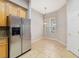 A bright dining space adjacent to the kitchen with tile flooring and a window at 8414 Frescada Ct, Orlando, FL 32836