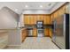 Bright kitchen featuring stainless steel appliances, granite countertops, and ample cabinet space at 8414 Frescada Ct, Orlando, FL 32836
