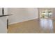 Minimalist living space with tiled floor, access to the exterior through sliding glass doors at 8414 Frescada Ct, Orlando, FL 32836