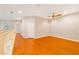 A spacious loft space with hardwood floors, a ceiling fan, and plenty of natural light at 8414 Frescada Ct, Orlando, FL 32836