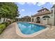 Community pool with lounge chairs and a pool house, surrounded by lush landscaping at 8414 Frescada Ct, Orlando, FL 32836