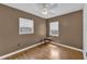 This cozy bedroom features hardwood floors, two windows, and a ceiling fan at 849 Driver Ave, Winter Park, FL 32789