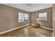 Cozy bedroom featuring hardwood floors, neutral paint, white trim, and natural light at 849 Driver Ave, Winter Park, FL 32789