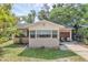 Charming single-story home featuring a cozy front porch and well-maintained lawn with mature trees at 849 Driver Ave, Winter Park, FL 32789