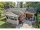 Aerial view of single-story home featuring a small front porch, attached garage, and well-maintained lawn at 849 Driver Ave, Winter Park, FL 32789