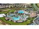 An aerial view showcases a resort-style pool and amenity center surrounded by lush landscaping and residences at 8990 Azalea Sands Ln # 8990, Davenport, FL 33896