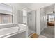 Bright bathroom features a soaking tub, glass enclosed shower, and neutral tile at 8990 Azalea Sands Ln # 8990, Davenport, FL 33896