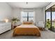 Bedroom with neutral tones, soft lighting, and a sliding glass door to a balcony at 8990 Azalea Sands Ln # 8990, Davenport, FL 33896