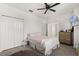Spacious bedroom featuring a ceiling fan, closet, dresser, and modern interior design at 8990 Azalea Sands Ln # 8990, Davenport, FL 33896