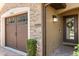 Home exterior features stone accents, a garage, and a covered front entrance at 8990 Azalea Sands Ln # 8990, Davenport, FL 33896