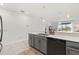 Modern kitchen featuring sleek cabinetry, a stylish sink, and a view of the home's living area at 8990 Azalea Sands Ln # 8990, Davenport, FL 33896