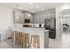 Modern kitchen with barstool seating, sleek appliances, and an open layout to the living area at 8990 Azalea Sands Ln # 8990, Davenport, FL 33896