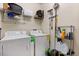Practical laundry room features a washer, dryer, wire shelving, and storage rack at 8990 Azalea Sands Ln # 8990, Davenport, FL 33896
