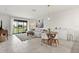 Open-concept living area flows from living room to dining area with bright, airy decor at 8990 Azalea Sands Ln # 8990, Davenport, FL 33896