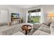 Bright and open living room with large windows and a view of the outdoors and the community at 8990 Azalea Sands Ln # 8990, Davenport, FL 33896
