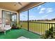 Screened patio with a cozy chair and view of green lawn at 8990 Azalea Sands Ln # 8990, Davenport, FL 33896