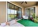 Relaxing covered patio with a swing chair and sliding glass doors at 8990 Azalea Sands Ln # 8990, Davenport, FL 33896