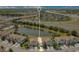 A vibrant aerial view of townhomes near a serene pond and convenient highway access at 9069 Shepton St, Orlando, FL 32825