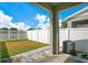 A small fenced-in backyard with a concrete patio and an AC unit along the side of the house at 9069 Shepton St, Orlando, FL 32825