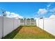 Fenced backyard with a gate leading to a scenic pond view for outdoor enjoyment at 9069 Shepton St, Orlando, FL 32825