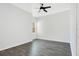 Bright bedroom featuring wood-look floors, neutral walls, a ceiling fan, and a window at 9069 Shepton St, Orlando, FL 32825