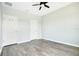 Bright bedroom featuring wood-look floors, neutral walls, ceiling fan, and a window at 9069 Shepton St, Orlando, FL 32825