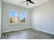 Bright bedroom featuring wood-look floors, neutral walls, and dual windows overlooking the community at 9069 Shepton St, Orlando, FL 32825