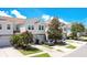 A beautiful exterior view of townhomes with well-manicured lawns and private parking spaces at 9069 Shepton St, Orlando, FL 32825