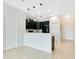 Open-concept living space with neutral tile flooring and a kitchen bar at 9069 Shepton St, Orlando, FL 32825