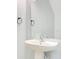 A simple powder room features a pedestal sink and sleek faucet, with a minimalistic style at 9069 Shepton St, Orlando, FL 32825