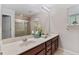A double vanity bathroom with granite counters and a tiled shower with glass doors at 976 Eagle Bay St, Winter Springs, FL 32708