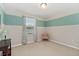 This bedroom has neutral walls with a blue stripe, carpet floors and a large window at 976 Eagle Bay St, Winter Springs, FL 32708