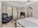 Spacious bedroom with silver bed frame, sitting area, ample natural light, and tray ceilings at 976 Eagle Bay St, Winter Springs, FL 32708