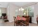 Bright dining area featuring a round table, comfortable seating, and views of the outdoor landscape at 976 Eagle Bay St, Winter Springs, FL 32708