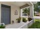 Welcoming front porch featuring neutral tones, stylish decor, and a peek into a quiet neighborhood street at 976 Eagle Bay St, Winter Springs, FL 32708