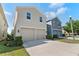 Neutral-colored two-story homes with two-car garages sit side-by-side along a concrete driveway at 976 Eagle Bay St, Winter Springs, FL 32708