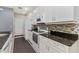 Well-equipped kitchen featuring white cabinets, dark countertops, and modern appliances at 976 Eagle Bay St, Winter Springs, FL 32708
