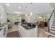 Spacious kitchen open to the living room, featuring a breakfast bar, modern appliances, and a staircase at 976 Eagle Bay St, Winter Springs, FL 32708