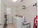 Bright laundry room featuring modern appliances and ample storage shelving at 976 Eagle Bay St, Winter Springs, FL 32708