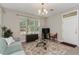 Cozy living room area with a comfortable sofa, modern media center, and natural light from the window at 976 Eagle Bay St, Winter Springs, FL 32708